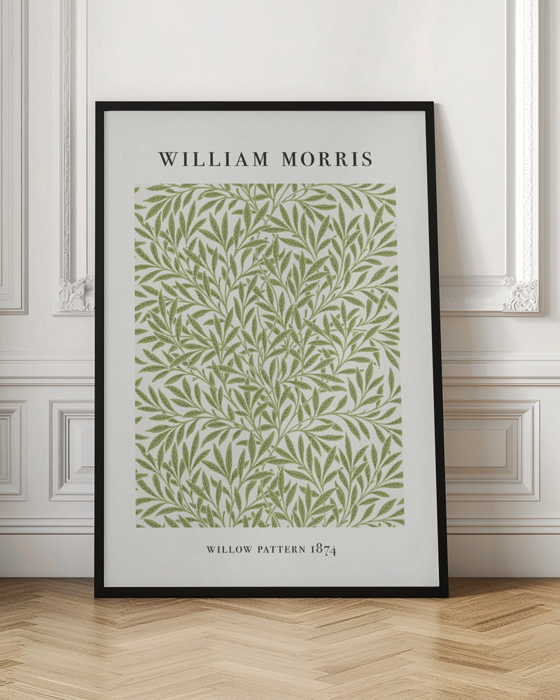 A framed art print of William Morris's 'Willow Pattern 1874'. The print features an intricate, repeating pattern of green willow branches and leaves on an off-white background, with the artist's name and pattern title in black text above and below the design. Print