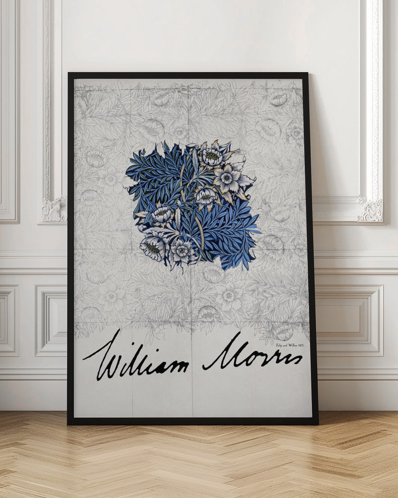 A framed vintage art print by William Morris. The artwork showcases a central colored sample of an intricate blue, white, and gold floral and foliage pattern, laid over a faint grayscale sketch of a similar repeating design. Below, the artist's name 'William Morris' is written in a large, black, cursive script. Print