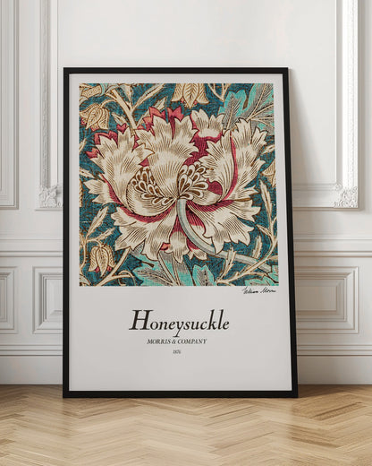 A vintage art print by William Morris titled 'Honeysuckle' from 1876. The design features a large, stylized cream and red honeysuckle flower on a detailed background of teal leaves and smaller tan flowers. The poster has a white border with text and is in a black frame. Wall Art