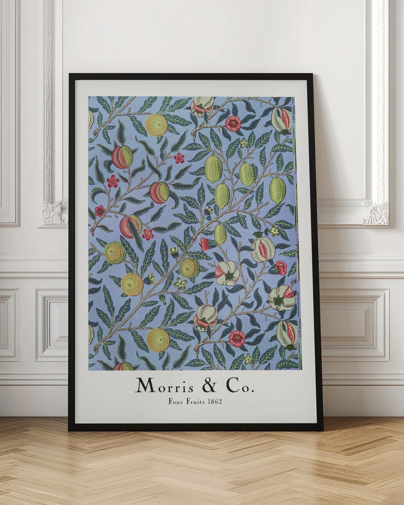 A framed art print of the 'Four Fruits 1862' pattern by Morris & Co. The intricate botanical design features various fruits like lemons, pomegranates, and oranges, along with red and yellow flowers, all intertwined on branches with dark green leaves against a light blue background. Poster