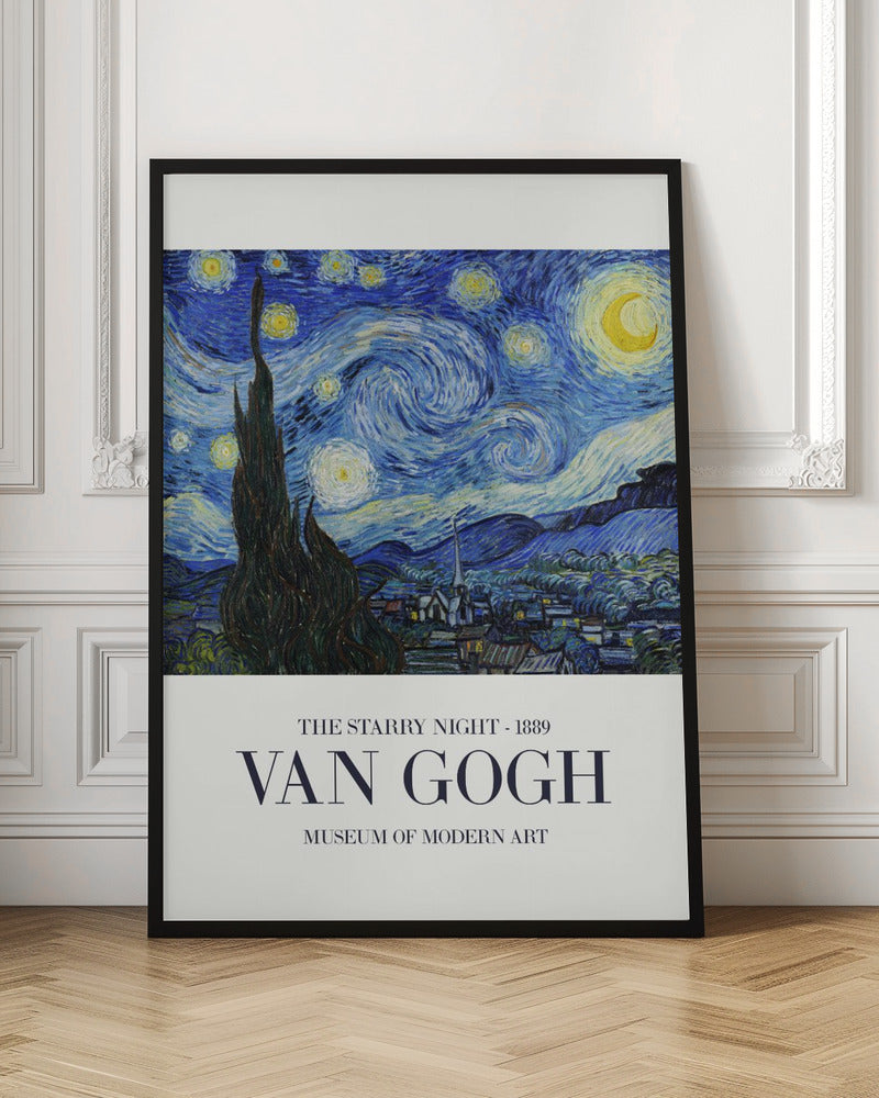 A framed art print of Vincent van Gogh's 'The Starry Night' from 1889. The painting depicts a dramatic, swirling night sky in deep blues and yellows, with a bright crescent moon and glowing stars. A large, dark cypress tree stands in the foreground, reaching towards the sky, with a peaceful village nestled in the hills below. The poster has a white border at the bottom with the text 'THE STARRY NIGHT - 1889', 'VAN GOGH', and 'MUSEUM OF MODERN ART'. Wall Art