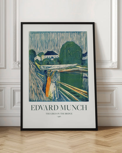 A framed poster of Edvard Munch's 1918 woodcut 'The Girls on the Bridge'. The expressionist artwork depicts three women on a bridge in a vibrant palette of green, blue, and orange, with a village scene in the background. Print