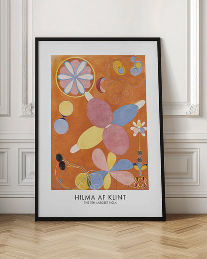 An art poster of Hilma af Klint's painting 'The Ten Largest No.4'. The abstract artwork features colorful, biomorphic and floral shapes in pink, blue, and yellow against a vibrant orange background. The poster has a white border with the artist's name and title at the bottom, all framed in black. Decor