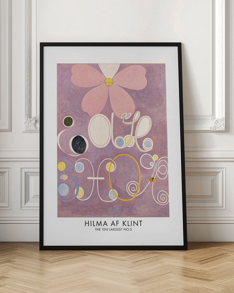 A framed art print of Hilma af Klint's painting 'The Ten Largest, No. 5'. The abstract artwork features a large pink flower at the top against a lavender background, with large, stylized white letters and symbols below, accented with circles of yellow, blue, and black. Poster
