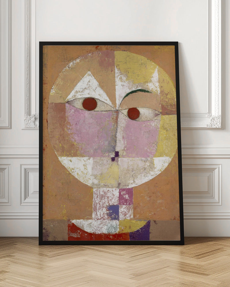 An abstract portrait painting of a stylized head, often identified as Paul Klee's 'Senecio'. The face is composed of geometric blocks of color, including pink, yellow, and white, with two prominent red circles for eyes, all set against a textured, earthy orange and brown background within a black frame. Print