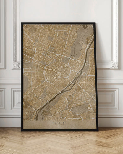 A vintage-style map of Munich, Germany, displayed in a black frame. The map is rendered in shades of brown and beige, with roads and rivers highlighted in white, creating a detailed and artistic representation of the city's layout. At the bottom, the words 'MÜNCHEN' and 'DEUTSCHLAND' are printed. Poster