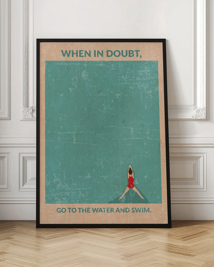 A vintage-style motivational poster featuring an overhead view of a woman in a red swimsuit floating in teal water. Text at the top reads, 'WHEN IN DOUBT,', and text at the bottom says, 'GO TO THE WATER AND SWIM.' The poster has a distressed, weathered texture and is displayed in a black frame. Poster
