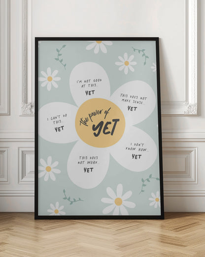 An inspirational poster in a black frame with a light green background and scattered daisy flowers. A large central daisy has 'The power of YET' in its yellow center. Each of its five white petals displays a negative self-talk phrase, such as 'I can't do this..' or 'I'm not good at this..', followed by the word 'YET' in bold, promoting a growth mindset. Print
