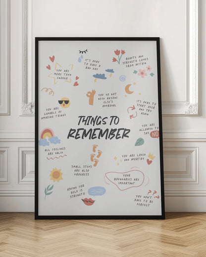 An inspirational poster in a black frame titled 'Things to Remember' in bold black script. It features a collection of handwritten positive affirmations in various colors, surrounded by small, charming doodles like hearts, a sun, a rainbow, and flowers. Key phrases include 'You are more than enough,' 'All feelings are valid,' and 'Your boundaries are important.' Print