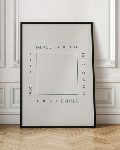 A minimalist art print in a black frame illustrating a box breathing exercise. A dark blue square is centered on an off-white background. The words 'INHALE', 'HOLD', 'EXHALE', and 'REST' are printed in blue around the square, corresponding to the top, right, bottom, and left sides, with four small circles along each side to guide the count. Decor