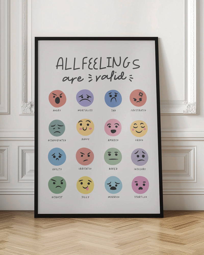 A framed poster titled 'ALL FEELINGS are valid' in a handwritten font. Below the title is a grid of 16 colorful circular emojis, each depicting a different emotion such as angry, happy, sad, and proud, with the name of the feeling written below each emoji. Wall Art