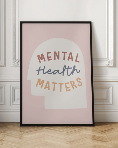 An inspirational art print with a light pink background featuring a cream-colored silhouette of a human head. Inside the silhouette, the phrase 'MENTAL Health MATTERS' is written in three different colors and fonts: rust red, slate blue script, and light orange. Wall Art