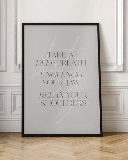 A minimalist typography art print with a light grey background and a thin black frame. The text, in a black serif font, reads 'TAKE A DEEP BREATH UNCLENCH YOUR JAW RELAX YOUR SHOULDERS'. A delicate, white script flourish is overlaid on the text. Wall Art