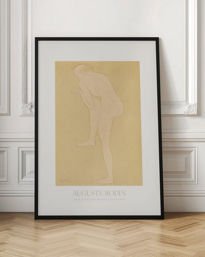 An art print of a sketch by Auguste Rodin titled 'Figure Bending Forward with Right Knee Raised'. The minimalist line drawing depicts a nude figure against a warm, yellow-beige background, matted in white and set in a simple black frame. Print