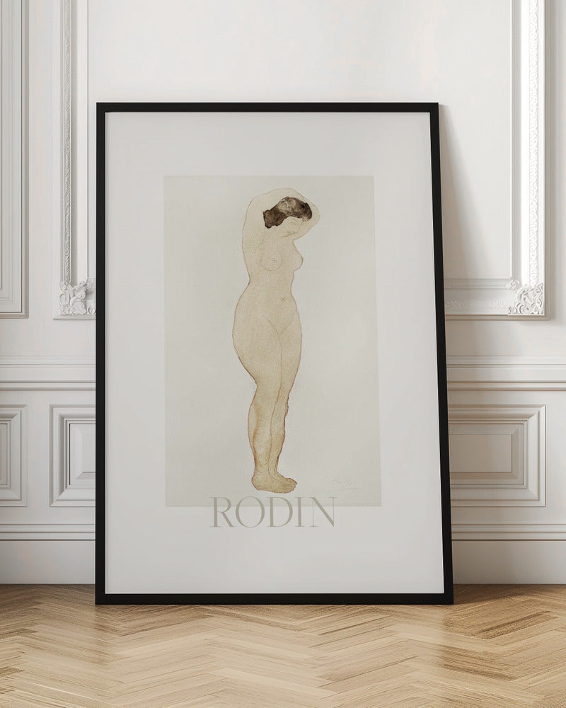A framed art print of a sketch by Auguste Rodin. The drawing features a standing nude woman in profile with her arms raised behind her head. The artwork is done in a minimalist style with brown outlines and a light beige watercolor wash on an off-white background, with the name 'RODIN' printed below. The print is surrounded by a white mat and a simple black frame. Decor