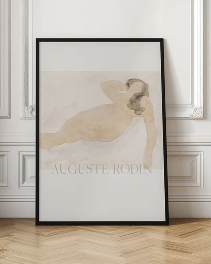 A framed watercolor painting by Auguste Rodin of a reclining nude woman. The figure is rendered in soft flesh tones and graphite with dark hair, set against a pale cream and beige background. The artist's name is printed in light text at the bottom. Poster