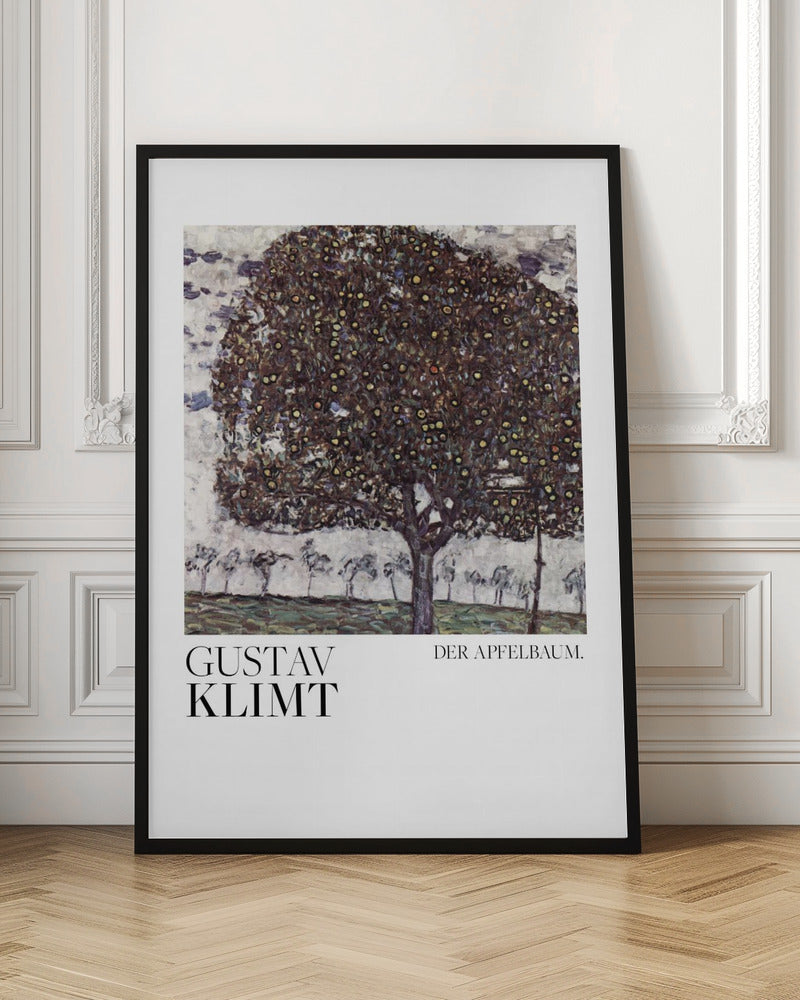 A framed art print of Gustav Klimt's painting 'Der Apfelbaum' (The Apple Tree). The impressionist-style painting depicts a large, full apple tree with a dark, textured canopy dotted with small yellow apples, set against a pale sky and a green meadow. Artwork
