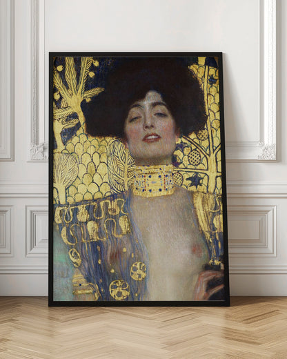 A vertical portrait painting by Gustav Klimt, 'Judith and the Head of Holofernes,' depicting a woman with voluminous dark hair and a sensual expression. She wears an elaborate gold and bejeweled choker, with a decorated blue and gold garment falling from her shoulders against a richly patterned gold leaf background. Artwork