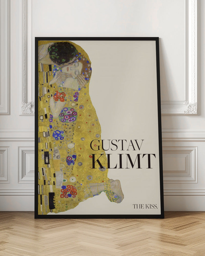 A poster of Gustav Klimt's painting 'The Kiss' featuring an embracing couple enveloped in ornate, golden robes. The artist's name 'GUSTAV KLIMT' and the title 'THE KISS' are printed in black text on a cream background, all within a black frame. Artwork