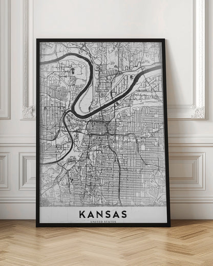 A modern, black and white line-art map of Kansas City, displayed in a black frame. The map details the intricate grid of streets and the winding path of a major river. At the bottom, a white border contains the word 'KANSAS' in bold, black capital letters. Artwork