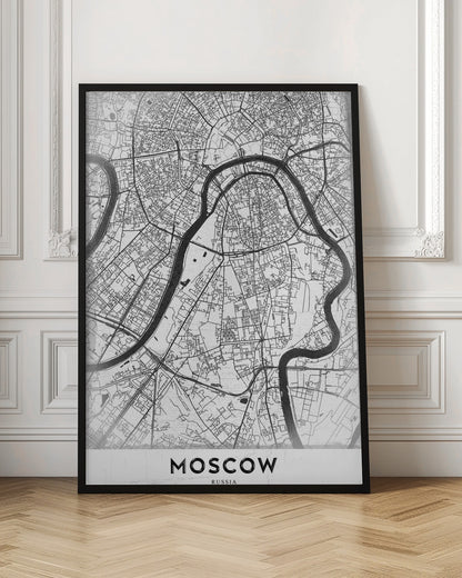 A framed, minimalist black and white street map of Moscow, Russia. The map details the intricate road network and the winding Moskva River. The word 'MOSCOW' is printed in large, black capital letters at the bottom. Print