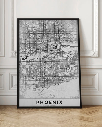 A minimalist black and white street map of Phoenix, Arizona, presented in a black frame. The map features a dense grid of roads on a lightly textured white background, with the city's name 'PHOENIX' printed in large, black capital letters at the bottom. Wall Art