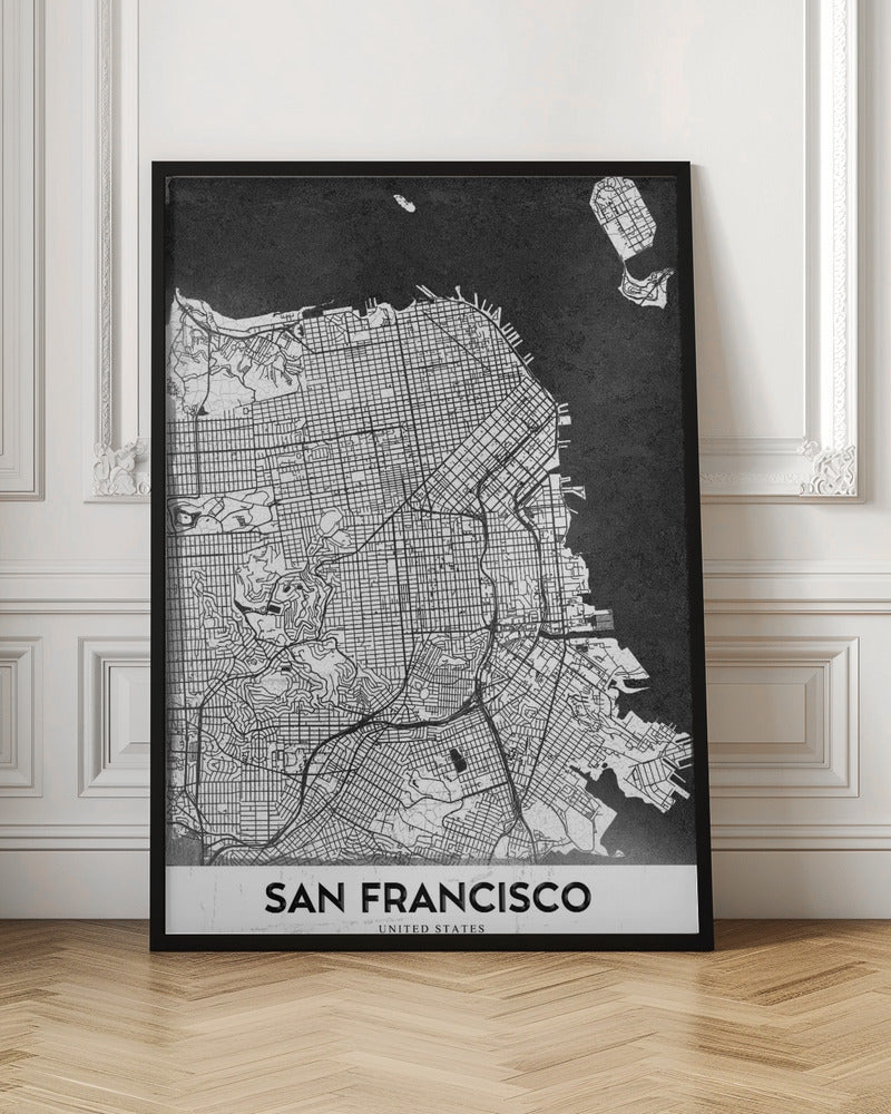 A minimalist black and white art print of a San Francisco city map. The street grid and landmass are depicted in white with fine black lines, set against a solid black background representing the water. A black frame surrounds the map, and a white banner at the bottom displays the text 'SAN FRANCISCO' in a bold, black font. Wall Art