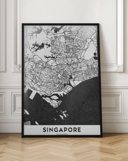 A framed, minimalist black and white art print of a map of Singapore. The land and road network are depicted in white with intricate black lines, while the surrounding water is a solid, textured black. At the bottom, the word 'SINGAPORE' is printed in black capital letters on a white banner. Decor