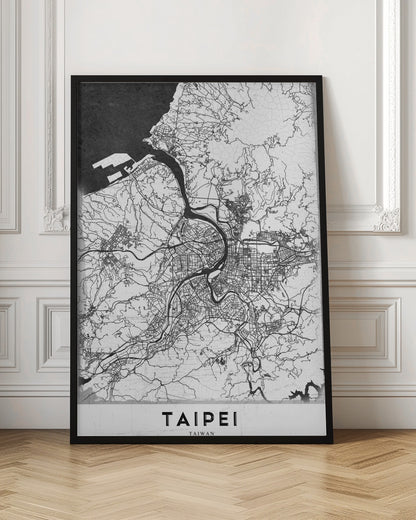 A minimalist black and white map of Taipei, Taiwan, styled as a poster. The intricate network of roads and rivers is rendered in thin black lines on a white background, with the ocean shown in solid black. The word 'TAIPEI' is printed in large, bold capital letters at the bottom. The entire map is enclosed within a thin black frame. Print