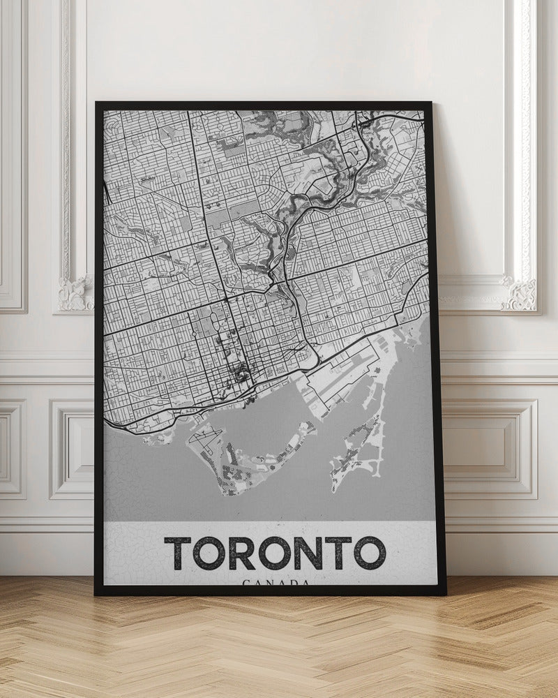 A modern, black and white poster featuring a stylized street map of Toronto, Canada. The map is in a black frame, and the word 'TORONTO' is written in bold, black, distressed letters at the bottom. Print