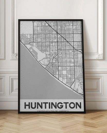 A minimalist black and white framed map of Huntington. The map details the city's street grid next to the coastline, with the name 'HUNTINGTON' printed in bold block letters at the bottom. Print