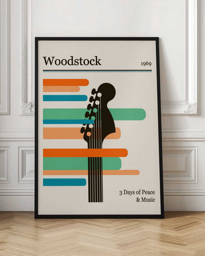 A minimalist retro-style poster for the 1969 Woodstock festival. It features a black silhouette of a guitar neck against horizontal stripes of orange, green, and blue on an off-white background. The text 'Woodstock 1969' is at the top, and '3 Days of Peace & Music' is at the bottom. Artwork