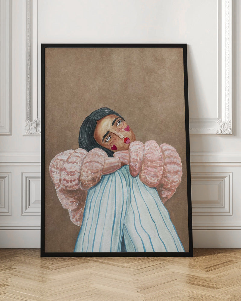 An illustrative painting of a person with dark hair, freckles, and red heart stickers on their cheeks. They are wearing a textured pink sweater and light blue pinstripe pants, hugging their knees while looking at the viewer with their head tilted against a solid brown background. Wall Art