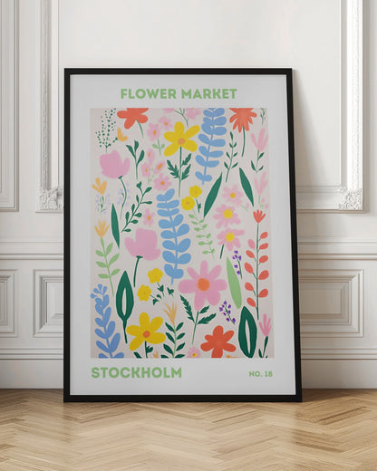 A framed art print of a 'Flower Market Stockholm' poster. It features a colorful, stylized illustration of various flowers and leaves in shades of pink, yellow, blue, and green against a cream background. The text is in a light green sans-serif font. Decor