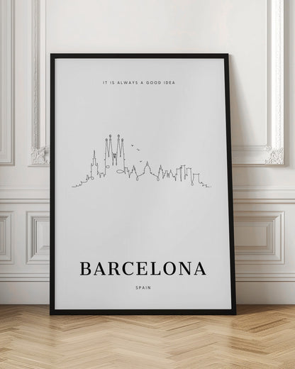 A minimalist black and white poster in a black frame featuring a single-line drawing of the Barcelona skyline. Above the skyline is the text 'IT IS ALWAYS A GOOD IDEA' and below it, the word 'BARCELONA' in large, bold letters with 'SPAIN' underneath. Artwork