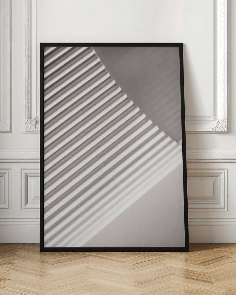 Abstract photograph of a ribbed surface with diagonal lines created by light and shadow, minimalist wall art.