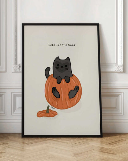 A cute cartoon illustration of a black cat sitting inside a hollowed-out orange pumpkin. Above the cat is the text 'here for the boos' in a simple font against a light beige background. The art is signed 'f.royle'. Artwork