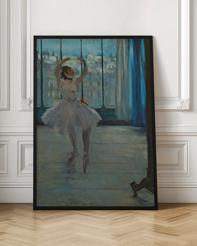 An impressionistic painting by Edgar Degas of a ballerina in a dance studio. The dancer, wearing a white tutu and pointe shoes, stands in a graceful pose with her arms raised above her head. She is positioned in front of a large window that looks out onto a hazy cityscape under a blue sky. The room has a wooden floor and a deep blue curtain to the right. Poster