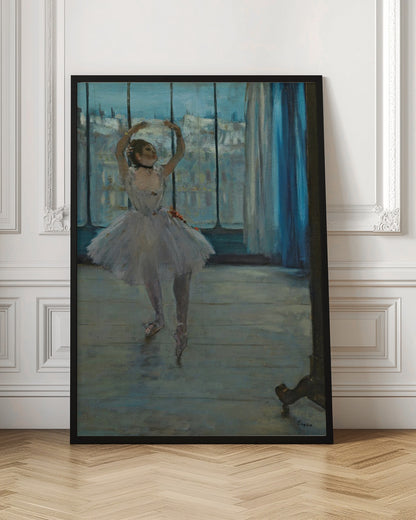 An impressionistic painting by Edgar Degas of a ballerina in a dance studio. The dancer, wearing a white tutu and pointe shoes, stands in a graceful pose with her arms raised above her head. She is positioned in front of a large window that looks out onto a hazy cityscape under a blue sky. The room has a wooden floor and a deep blue curtain to the right. Poster