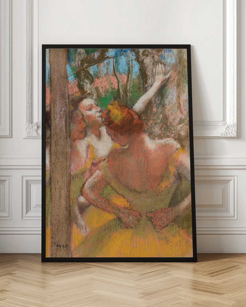 An Impressionist pastel drawing by Edgar Degas depicting several ballet dancers backstage. A dancer with reddish-orange hair is seen from behind in a yellow-green costume, while another dancer stretches an arm upwards. The background is a textured blend of blue, pink, and green. Decor