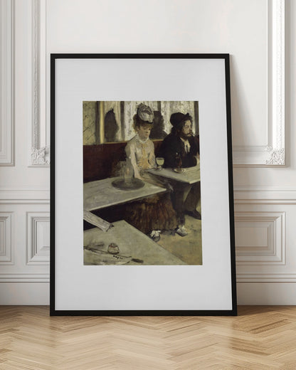 A framed print of Edgar Degas's painting 'L'Absinthe,' depicting a somber-looking man and woman sitting at adjacent tables in a 19th-century Parisian cafe, conveying a sense of alienation and melancholy. Print