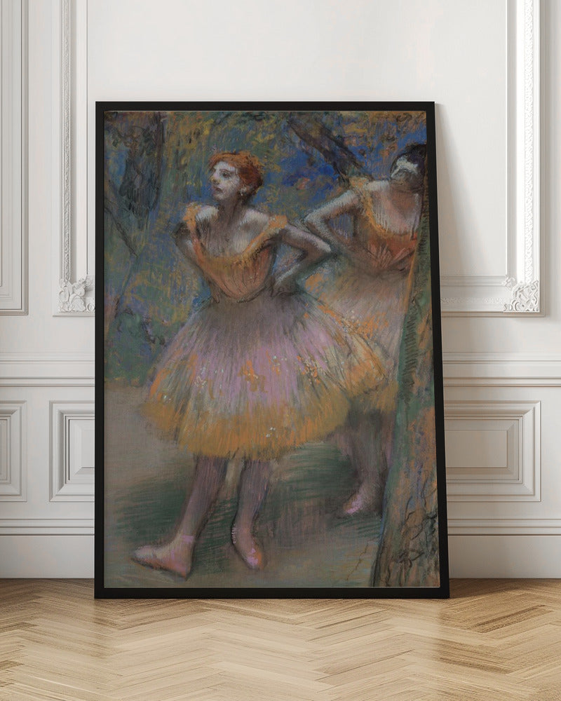 An impressionist pastel painting by Edgar Degas of two ballet dancers. The main dancer in the foreground has red hair and wears a pink and orange tutu. She stands with her hands on her hips, looking off to the left. The background is a blend of blue and green strokes, suggesting a backstage or outdoor setting. Decor