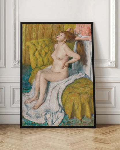 A pastel drawing by Edgar Degas of a nude woman with red hair sitting on a plush, chartreuse armchair. She leans her head back in pleasure as another person, likely a maid, stands behind her and combs her hair. The scene is intimate and rendered in an impressionistic style with visible pastel strokes. Artwork