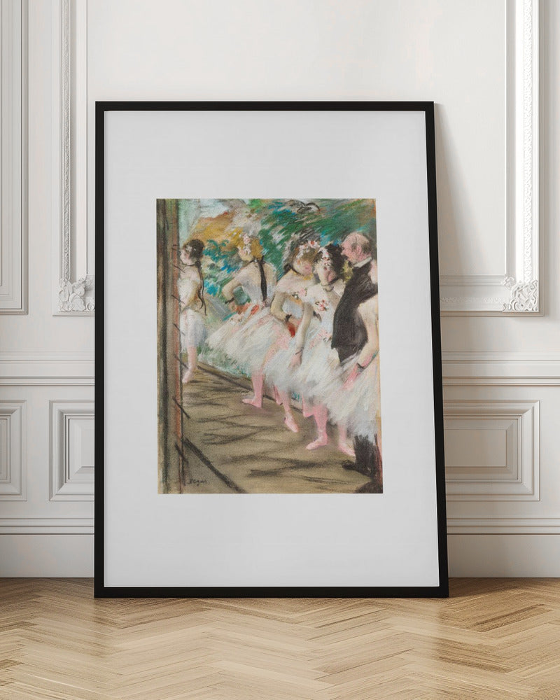 An Impressionist painting by Edgar Degas showing a group of ballet dancers in white tutus waiting in the wings of a stage. A man in a dark suit stands with them. The artwork is presented in a black frame with a white mat. Print