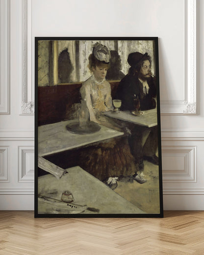 An impressionist painting by Edgar Degas, 'L'Absinthe', depicting a man and a woman sitting separately in a cafe. The woman in a light dress and hat looks downcast before a glass of pale green absinthe, while the bearded man next to her smokes a pipe and looks to the right. The scene is captured from an angle, with empty cafe tables in the foreground. Poster