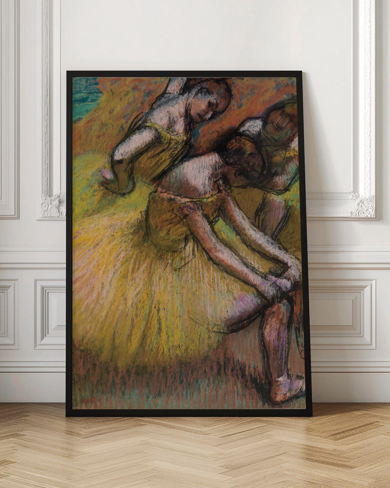 An impressionist pastel drawing of three ballet dancers in yellow tutus. One dancer is in the foreground, bent over to adjust her shoe, while two others are in the background. The artwork features a warm color palette with energetic, visible strokes. Decor