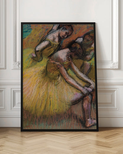 An impressionist pastel drawing of three ballet dancers in yellow tutus. One dancer is in the foreground, bent over to adjust her shoe, while two others are in the background. The artwork features a warm color palette with energetic, visible strokes. Decor