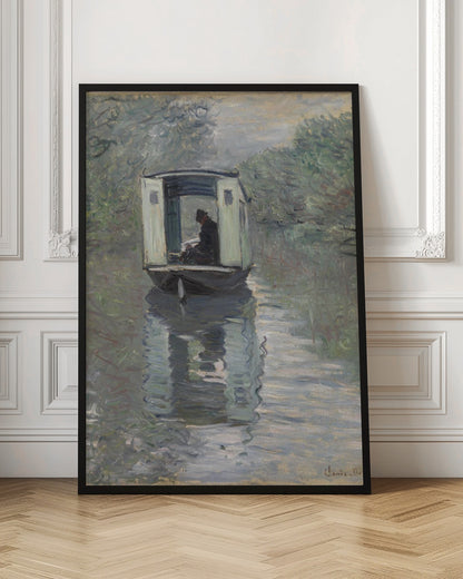 An Impressionist painting by Claude Monet titled 'The Studio Boat,' depicting a figure in a hat and dark coat sitting inside a small, white-paneled boat on a calm, grey-green river. The scene is enveloped in a soft, hazy light, with blurry trees lining the banks and a strong, rippling reflection of the boat in the water. Artwork