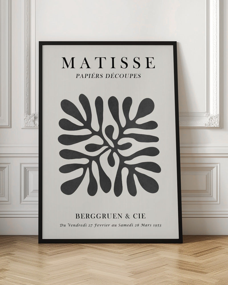 A framed black and white exhibition poster for Matisse's 'Papiers Découpés' at Berggruen & Cie in 1953. The poster features a central abstract black cutout shape resembling a sea plant on an off-white background with black serif typography. Poster