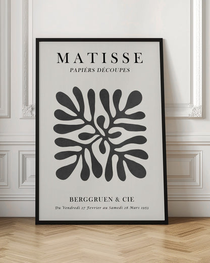 A framed black and white exhibition poster for Matisse's 'Papiers Découpés' at Berggruen & Cie in 1953. The poster features a central abstract black cutout shape resembling a sea plant on an off-white background with black serif typography. Poster